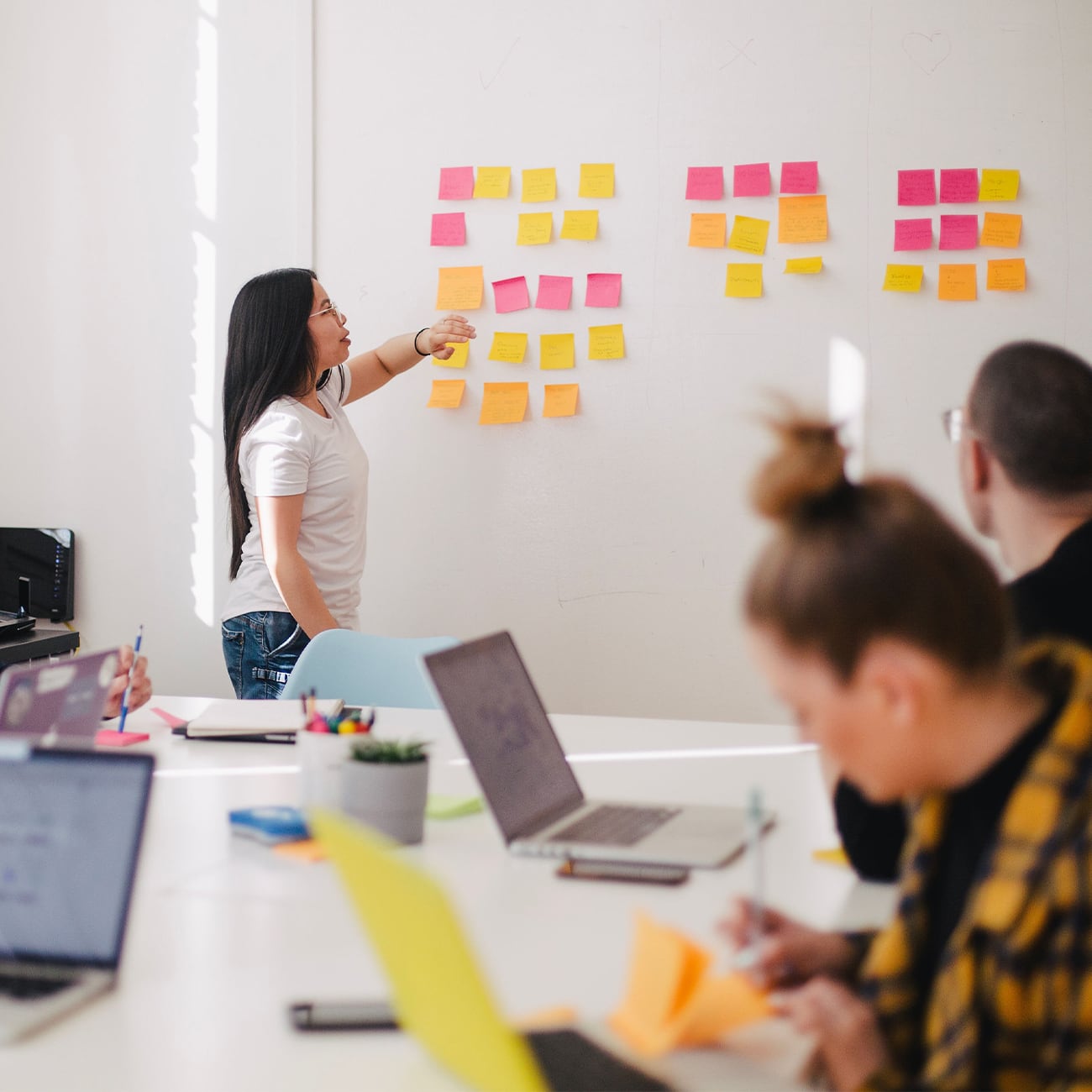 Woman facilitating business meeting with others