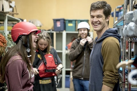 Adventure studies students putting on kayak gear